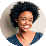 Headshot of a Black woman wearing a navy blue shirt with natural hair.