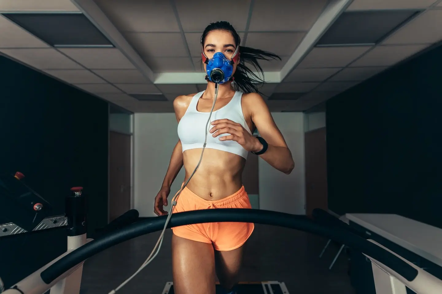 Woman running on treadmill for VO2 max testing with Prime Wellness.