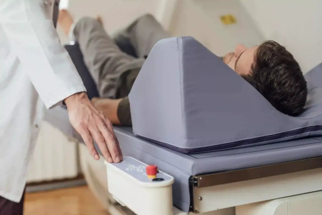 Natural health doctor physician guides patient through a dexa scan.